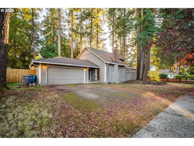 a aerial view of a house with a yard and garage