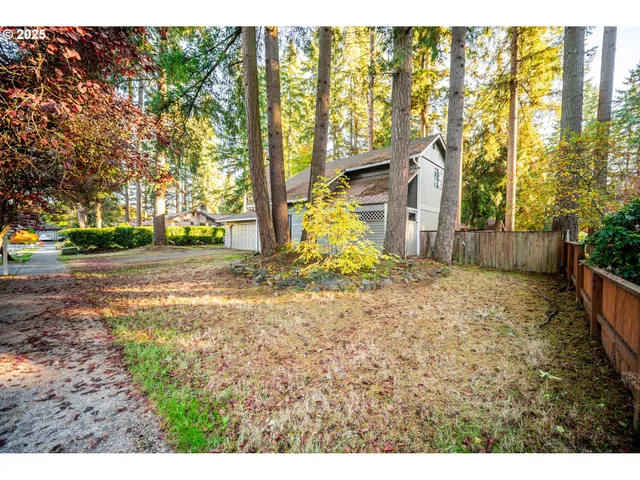 a backyard of a house with large trees
