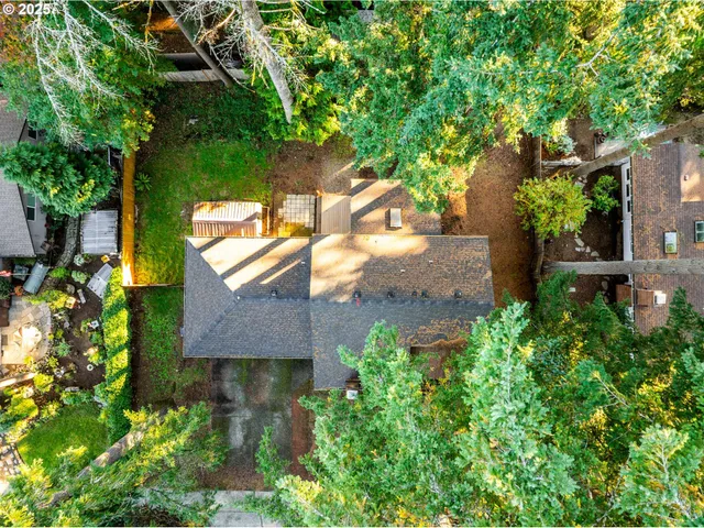 an aerial view of a house with a yard and garden