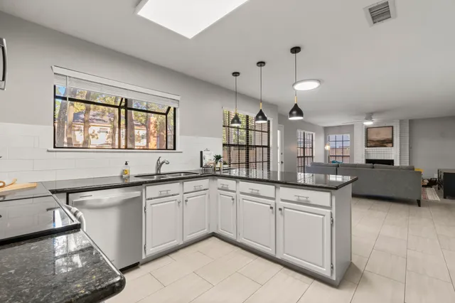 a kitchen with stainless steel appliances granite countertop a refrigerator sink and stove
