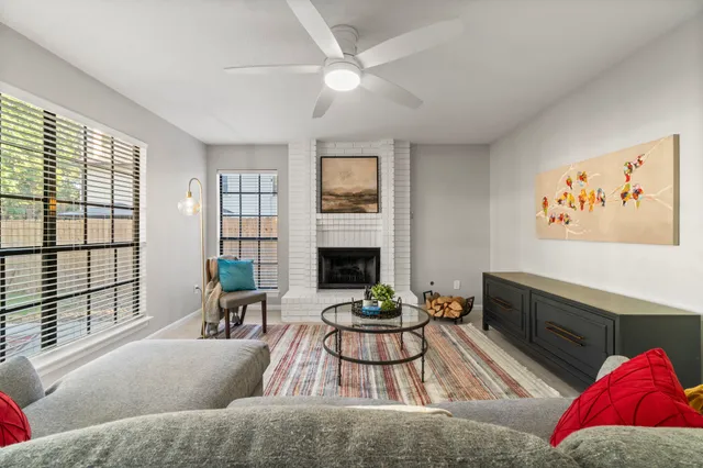 a living room with furniture fireplace and flat screen tv