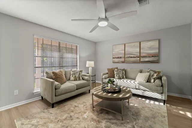 a living room with furniture and a large window