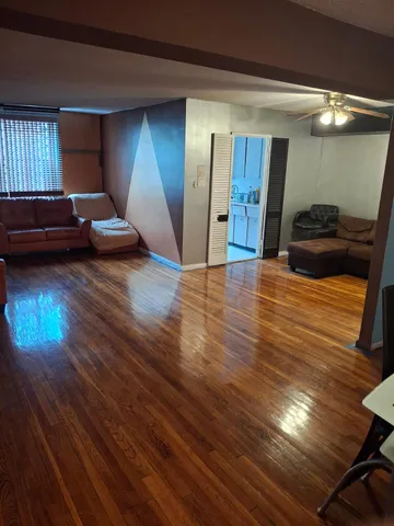 a view of a livingroom with furniture and a window