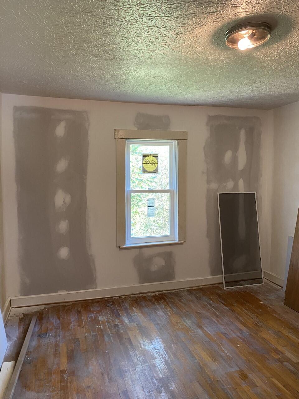 1050 Highland Road Thaxton, VA 24174 - Photo 12 of 31 an empty room with wooden floor and windows