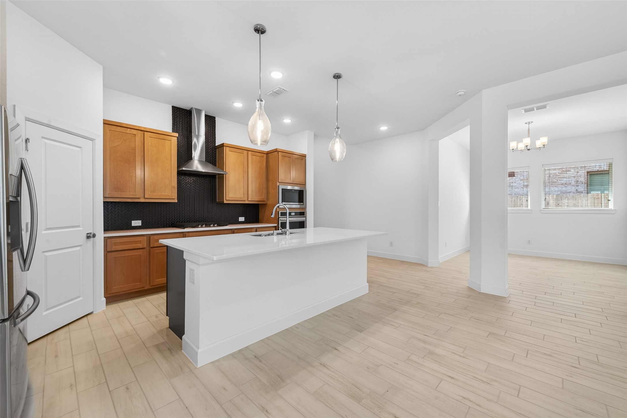 211 Amaranth Way Richmond, TX 77406 - Photo 19 of 26 a large kitchen with a lot of counter space and a refrigerator