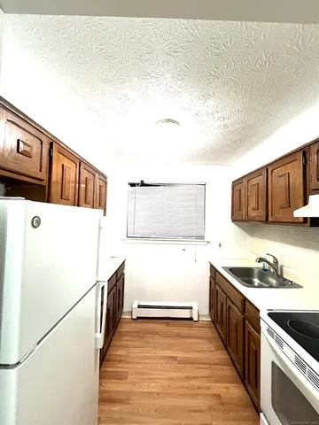 a kitchen with stainless steel appliances granite countertop a sink and a stove top oven