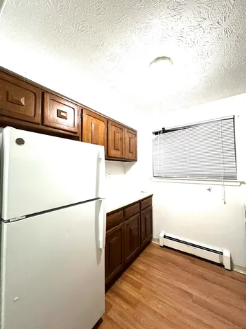 a kitchen with stainless steel appliances granite countertop a refrigerator a stove a sink and a microwave