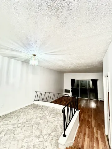 a bedroom with furniture and wooden floor