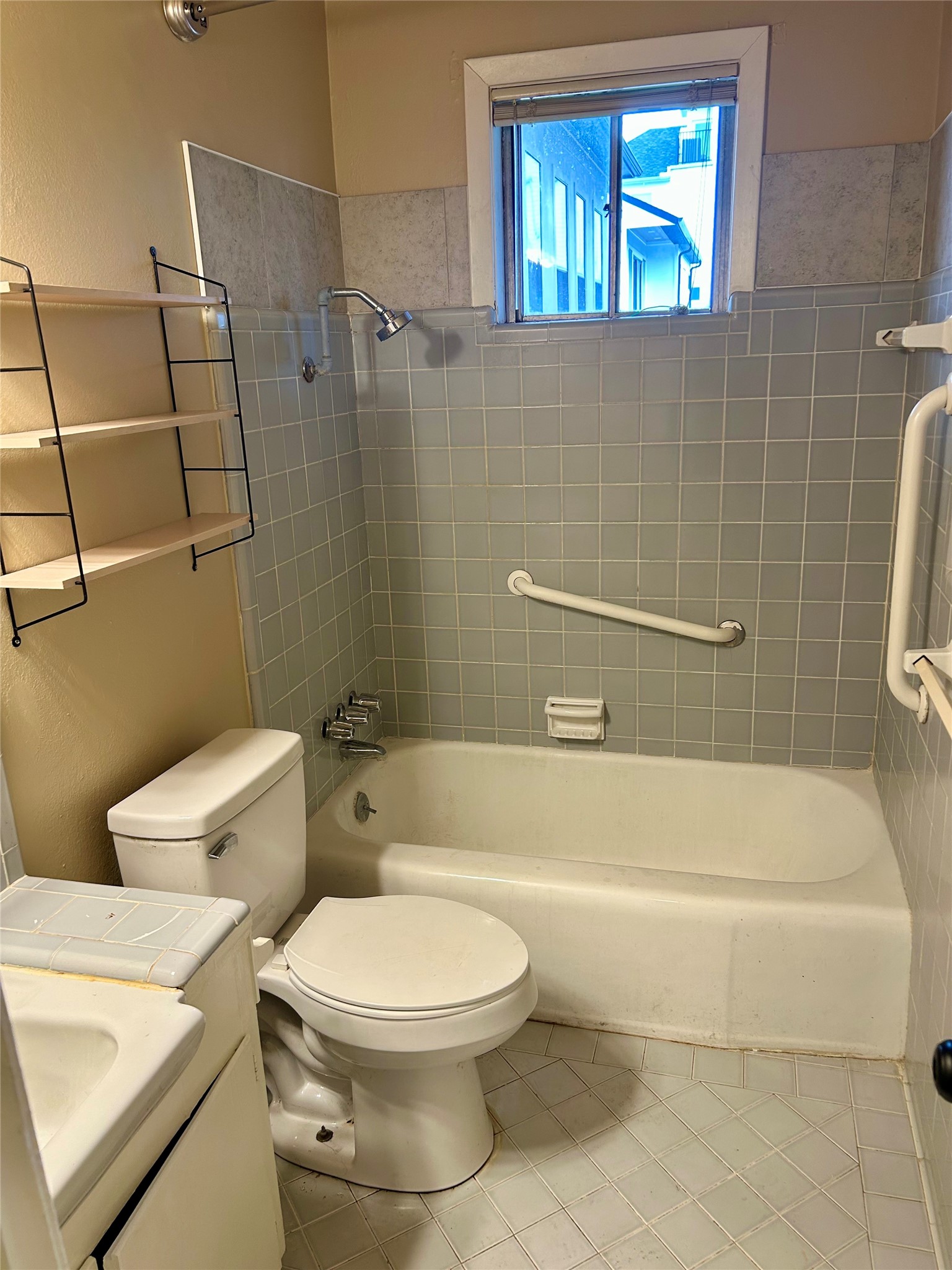 1411 Indiana Street, Unit 5 Houston, TX 77006 - Photo 11 of 14 a white toilet and tub sitting next to a bathroom sink