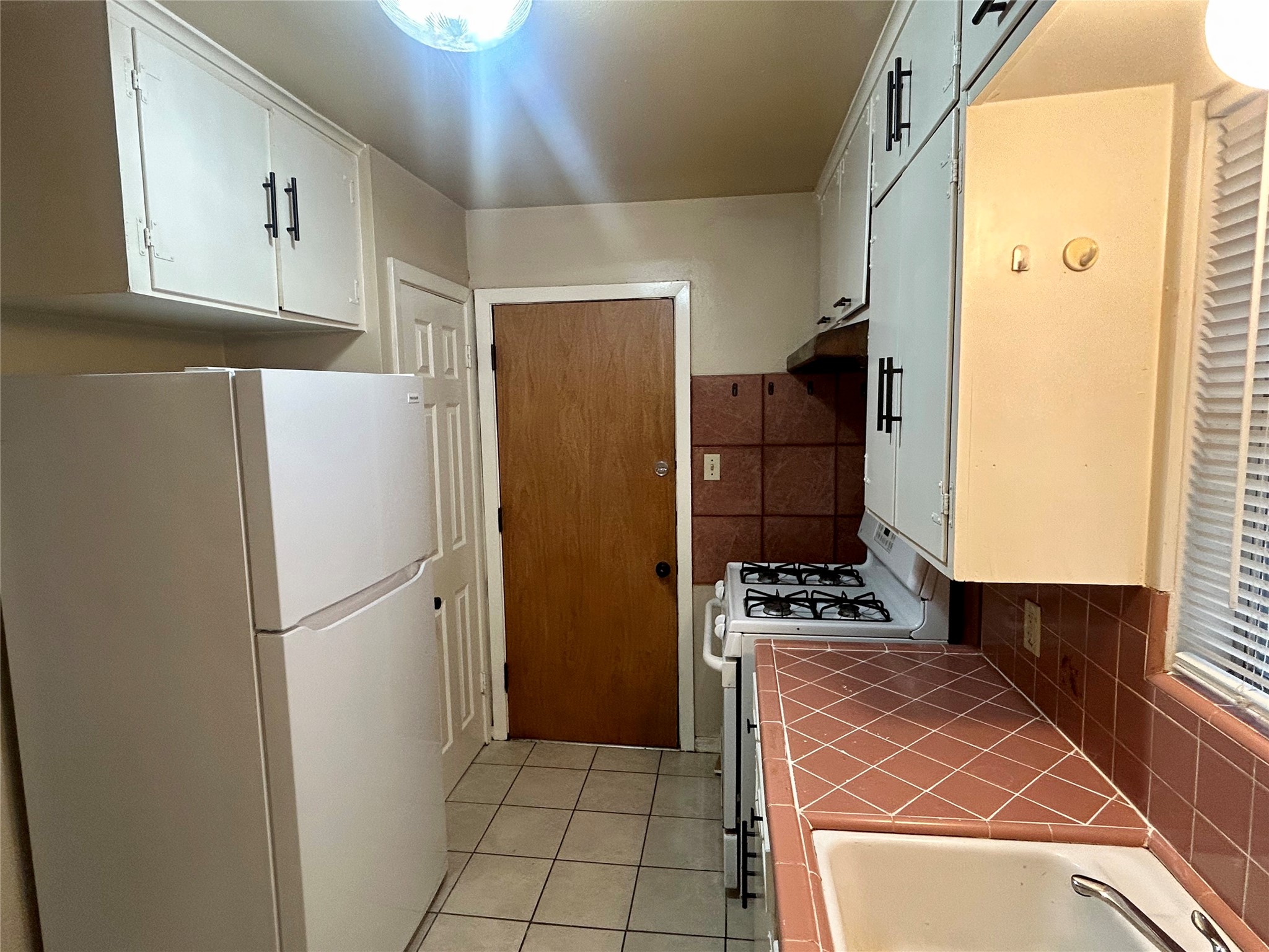1411 Indiana Street, Unit 5 Houston, TX 77006 - Photo 6 of 14 a kitchen with stainless steel appliances a refrigerator and a stove top oven