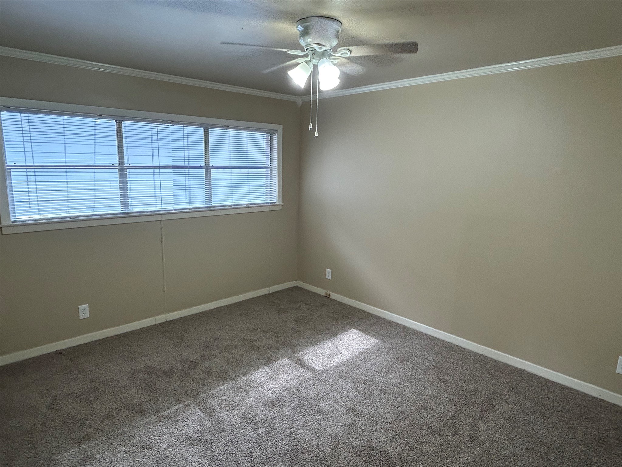 1411 Indiana Street, Unit 5 Houston, TX 77006 - Photo 7 of 14 an empty room with a window and a fan