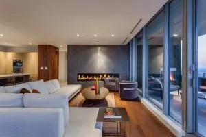 a living room with furniture kitchen view and a large window