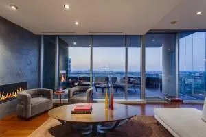 a living room with furniture kitchen view and a wooden floor