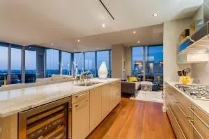 a bathroom with a granite countertop sink a mirror and a shower