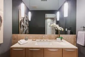 a bedroom with a bed and large windows