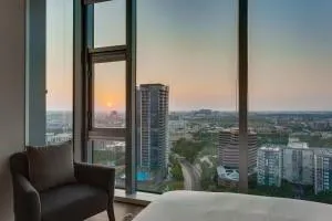 a bedroom with a large window and a bed