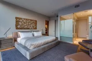 a bedroom with a large bed and a potted plant