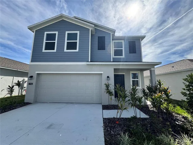 a front view of a house with plants