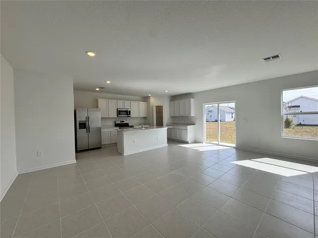 a view of kitchen with livingroom and window