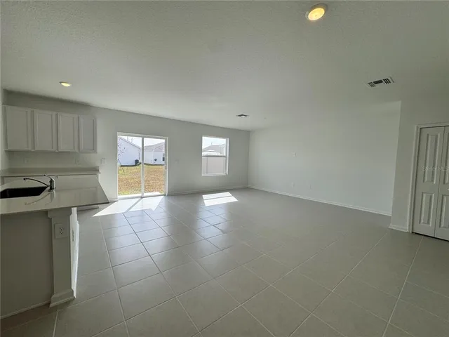 a view of a kitchen with a sink and a window