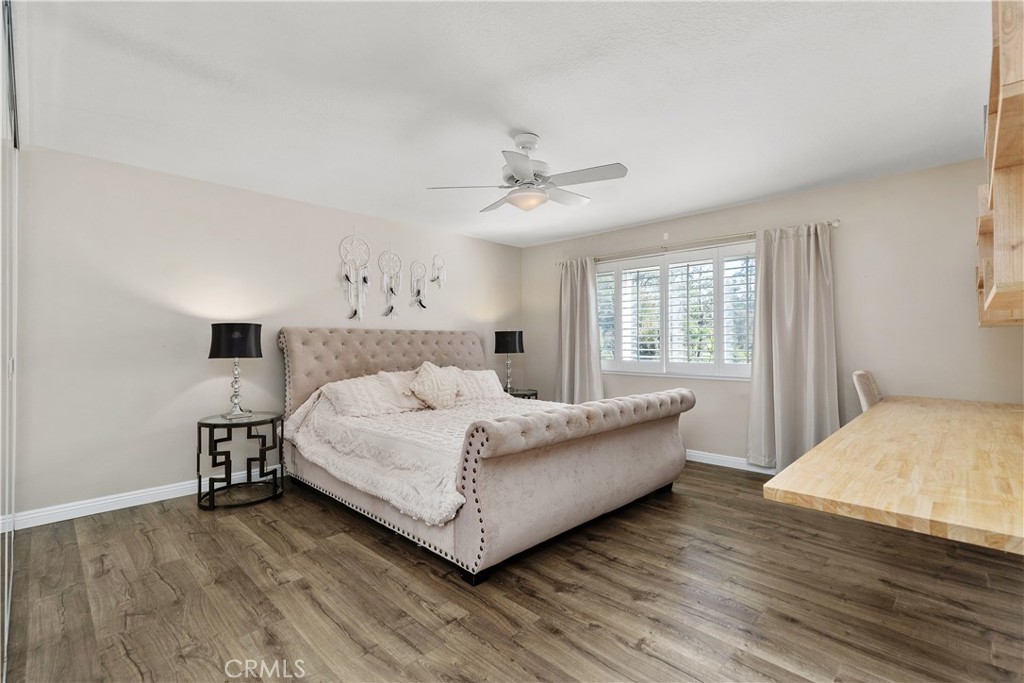 22876 Broadleaf Lake Forest, CA 92630 - Photo 19 of 53 Large primary bedroom with wood shutters and luxury vinyl flooring