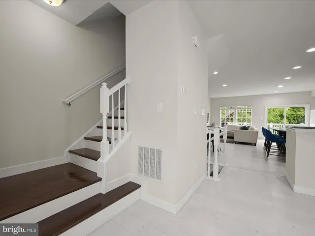 a kitchen with stainless steel appliances granite countertop stove a table and chairs
