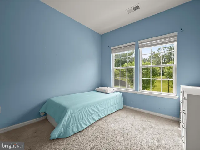 a bedroom with a bed and walk in closet