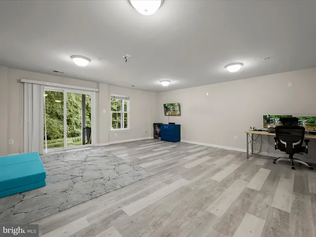 a bedroom with a bed and large window