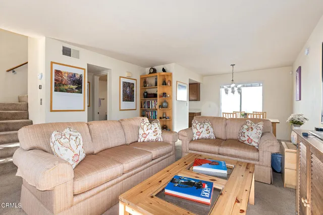 a living room with furniture window and a table