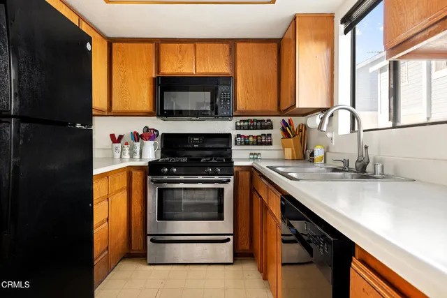 a kitchen with stainless steel appliances a stove sink and microwave