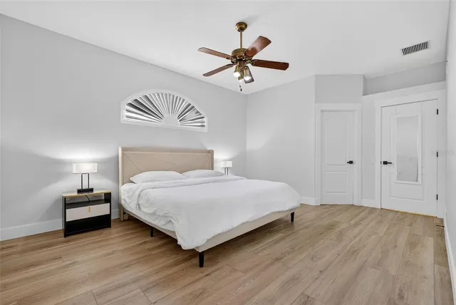 a bedroom with a bed and a chandelier