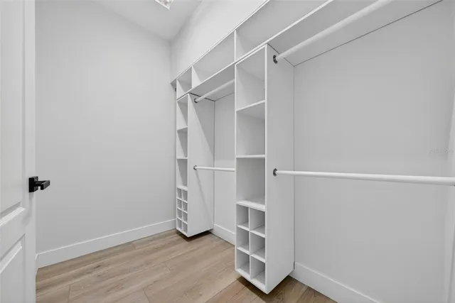 a bathroom with a double vanity sink a mirror a bathtub and shower