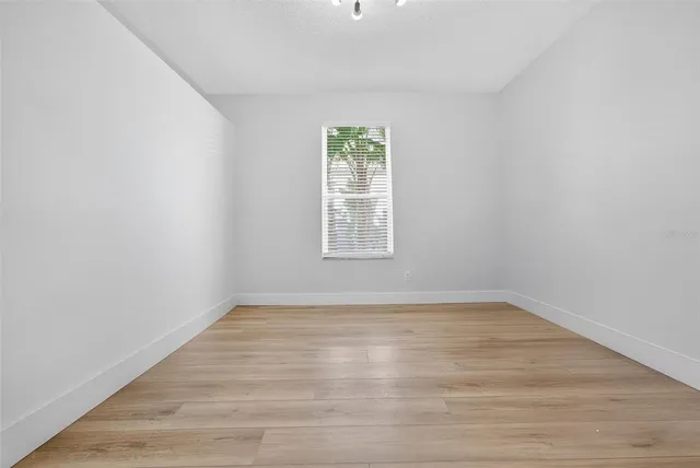 a blue bed sitting in a bedroom next to a window