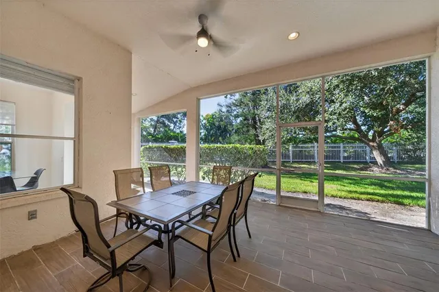 a living room with furniture and large windows