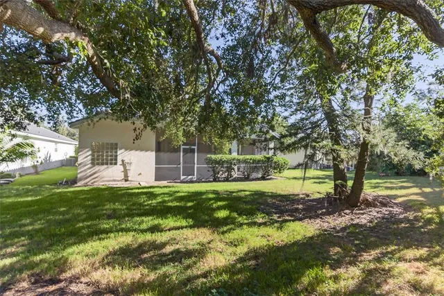 a view of a swimming pool with chairs in patio