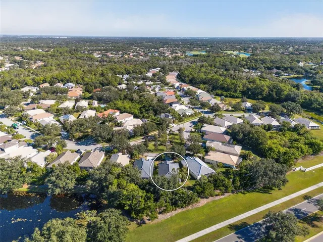 an aerial view of residential houses with outdoor space and river