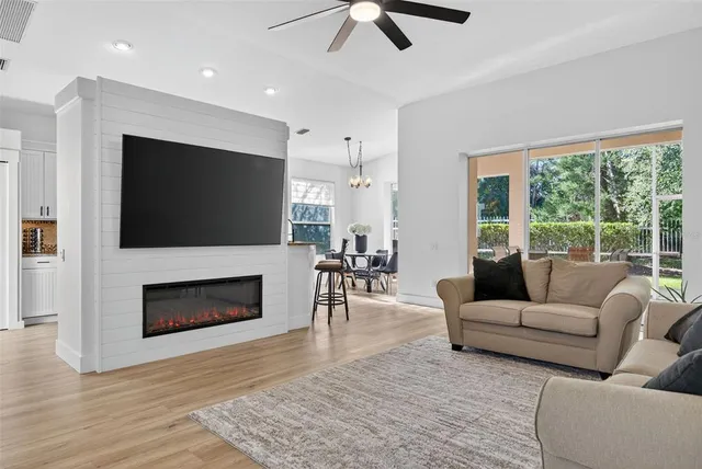 a living room with furniture fireplace and flat screen tv