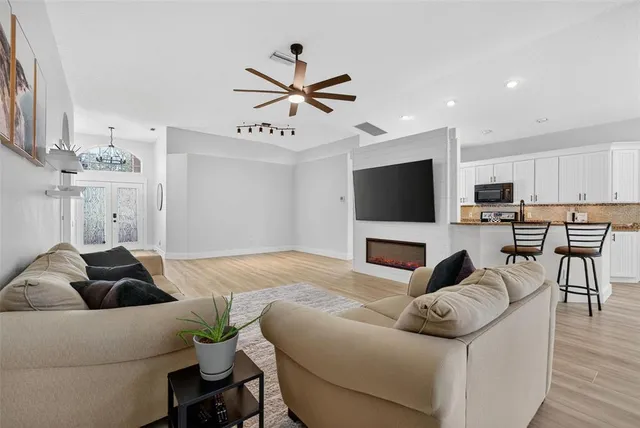 a kitchen with stainless steel appliances a stove a microwave a sink and cabinets