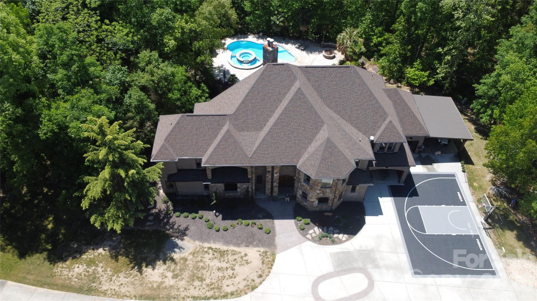a view of house with yard and sitting area