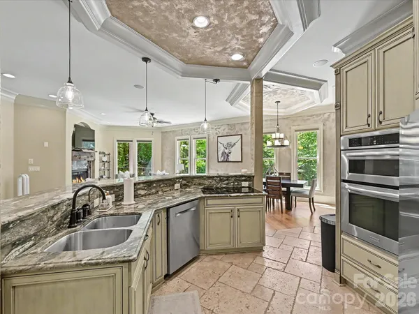 a kitchen with counter top space appliances and a large window