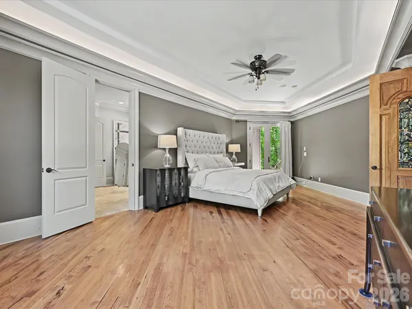 a bedroom with a bed and wooden floor