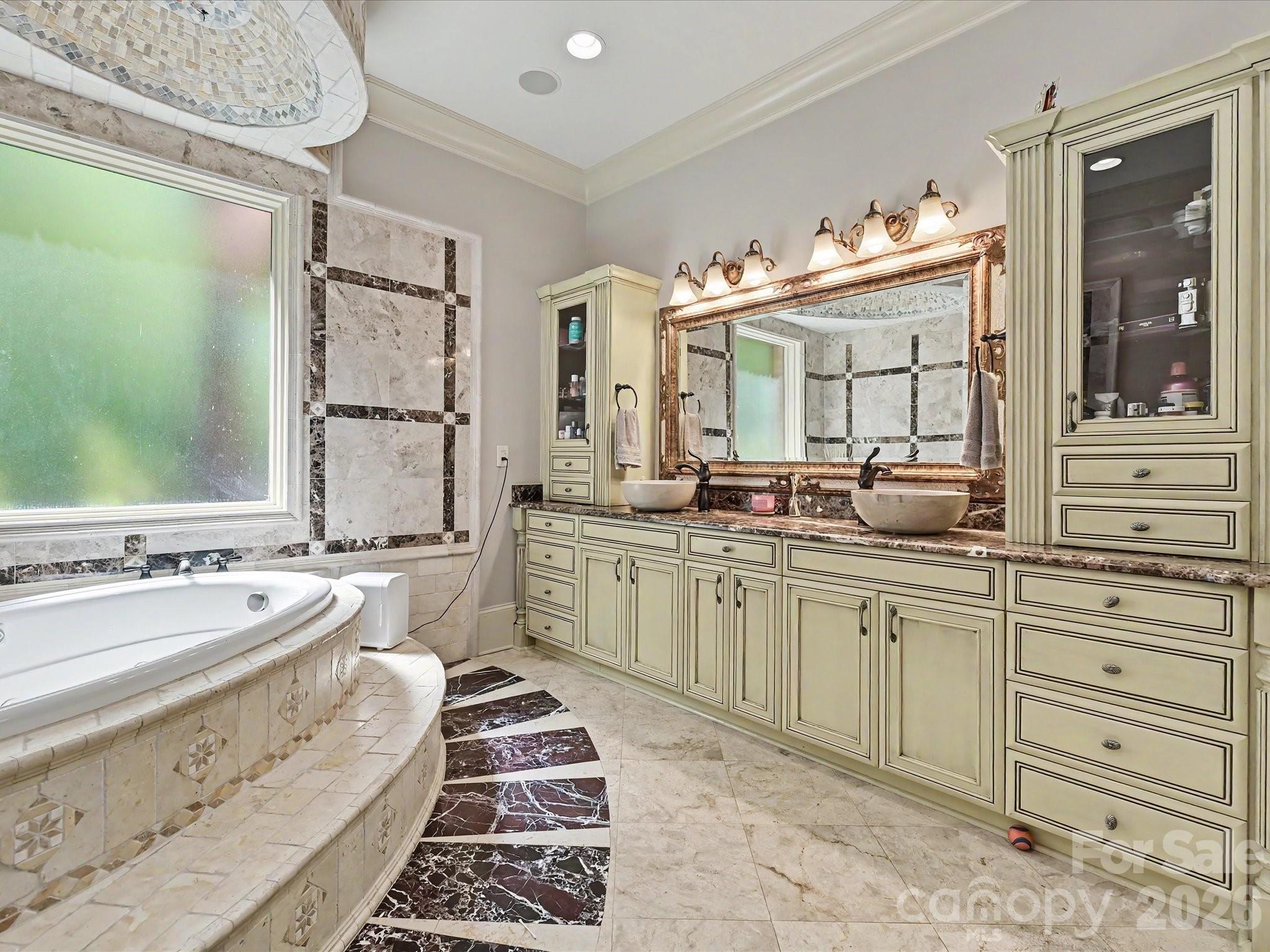 6112 Rehobeth Road Waxhaw, NC 28173 - Photo 17 of 48 a spacious bathroom with a double vanity sink a mirror a window and a bathtub
