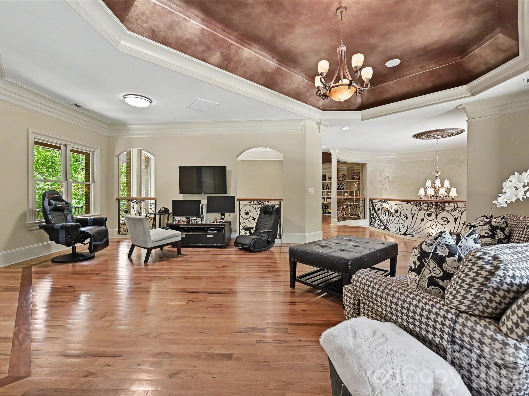 6112 Rehobeth Road Waxhaw, NC 28173 - Photo 20 of 48 a living room with furniture chandelier and a flat screen tv