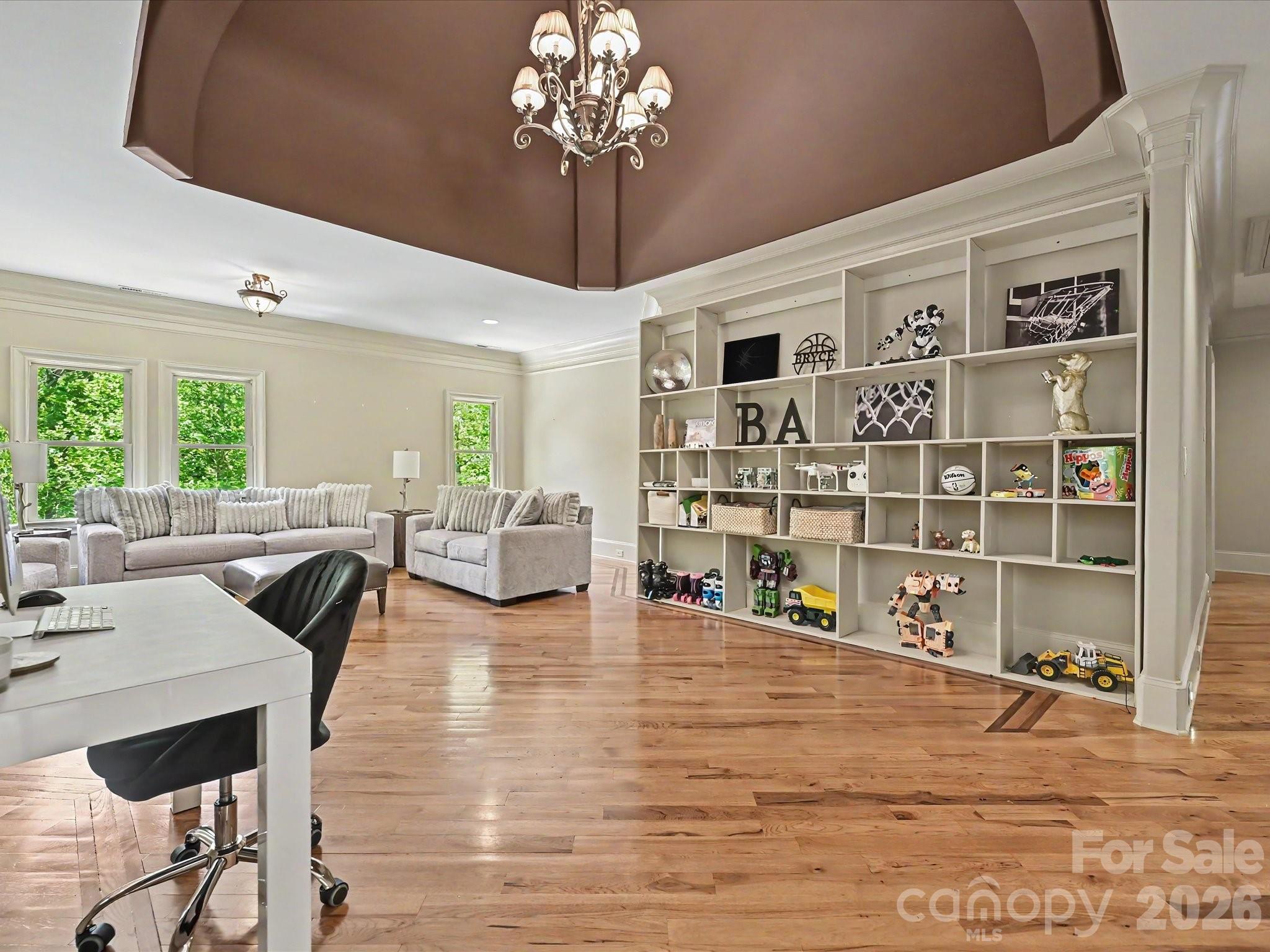 6112 Rehobeth Road Waxhaw, NC 28173 - Photo 21 of 48 a living room with furniture a chandelier and a dining table with wooden floor