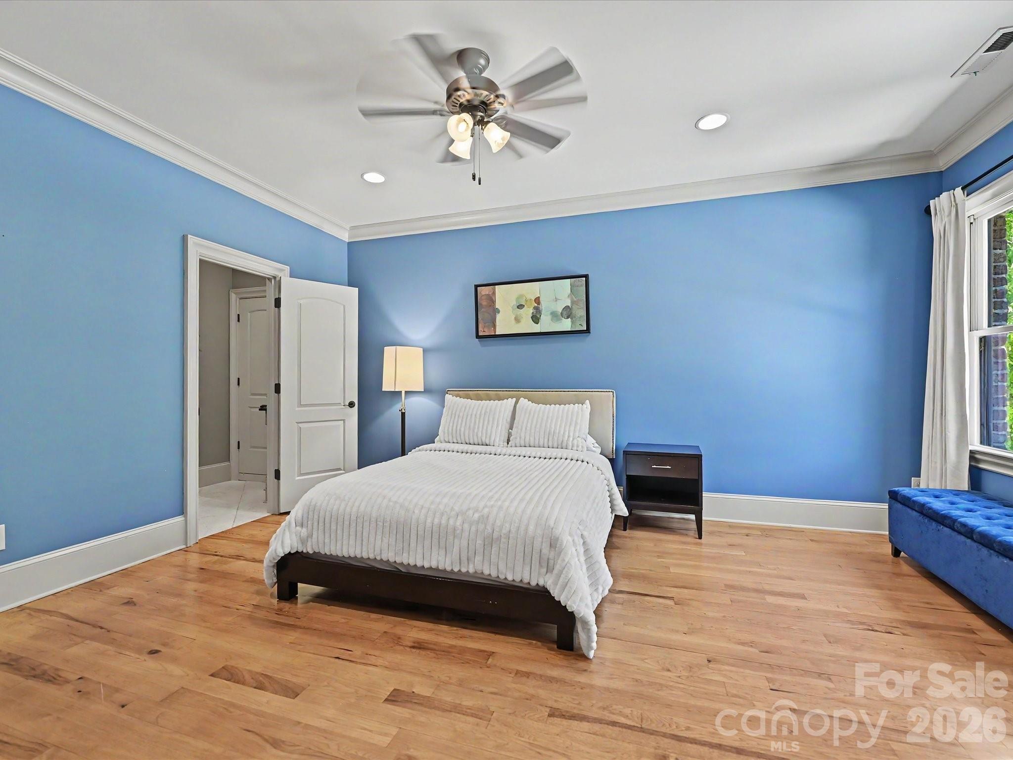 6112 Rehobeth Road Waxhaw, NC 28173 - Photo 25 of 48 a spacious bedroom with a bed and a chandelier