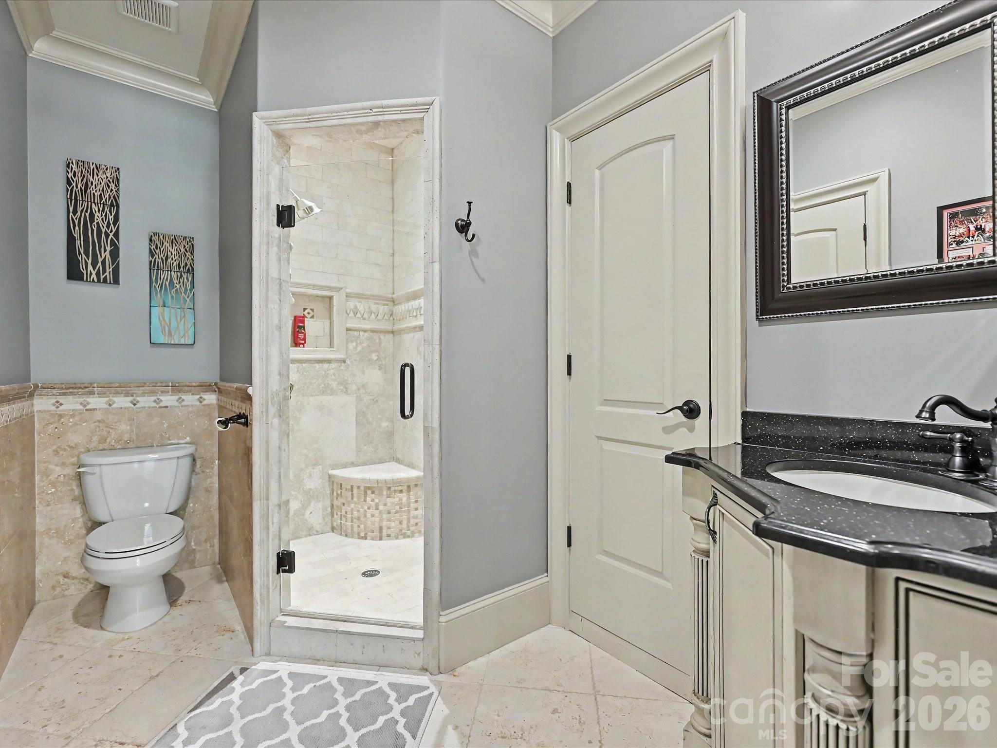 6112 Rehobeth Road Waxhaw, NC 28173 - Photo 26 of 48 a bathroom with a granite countertop sink a toilet a mirror and shower