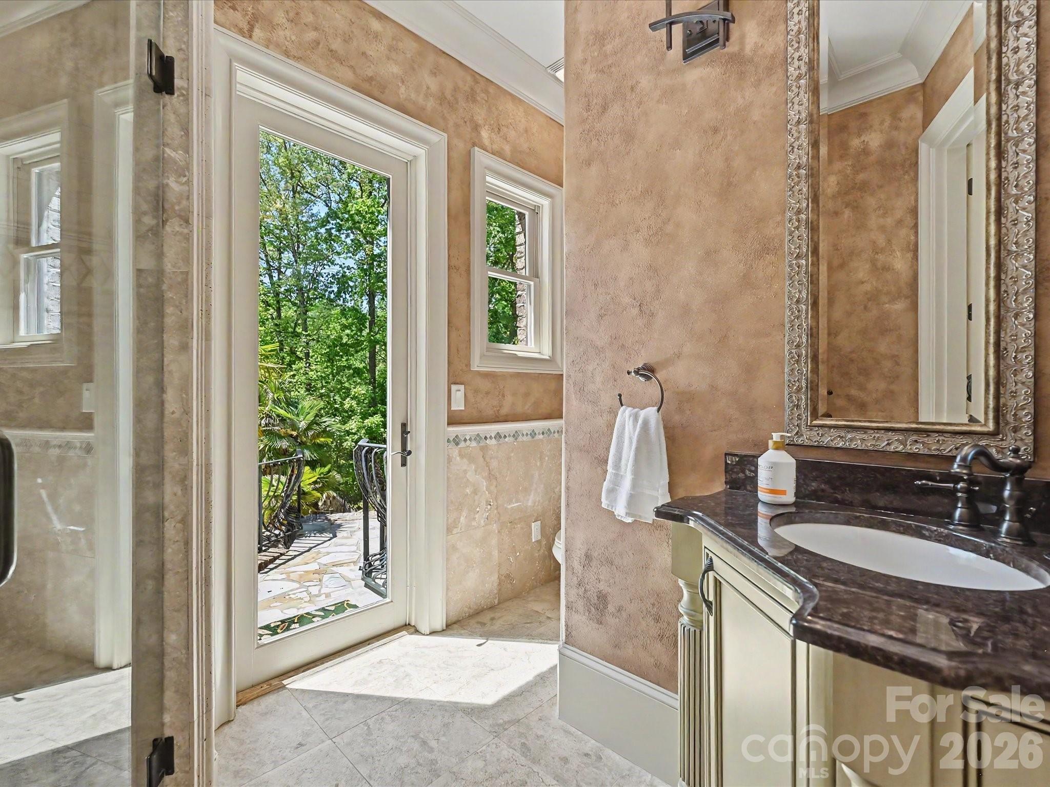 6112 Rehobeth Road Waxhaw, NC 28173 - Photo 37 of 48 a bathroom with a granite countertop sink a mirror and a shower