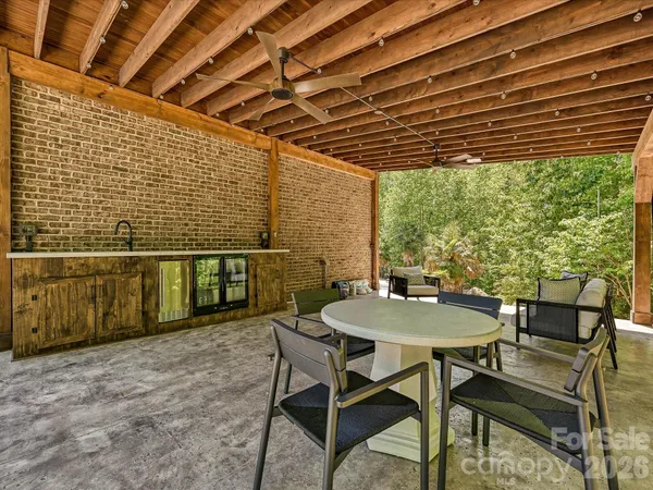a balcony with table and chairs