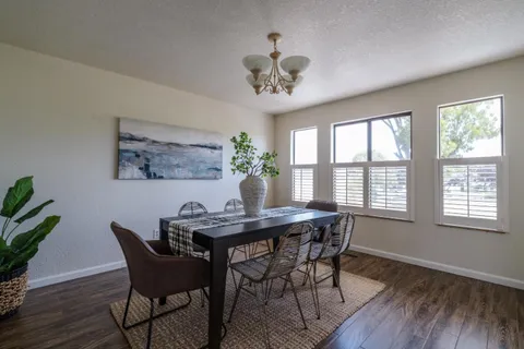 a dining room with furniture a rug and wooden floor