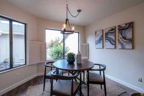 a dining room with furniture and window